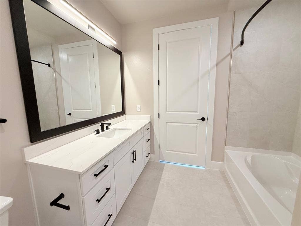 3255 Carlisle Street, #1207, Dallas, TX 75204 Full bathroom with vanity, tub / shower combination, and light tile patterned floors