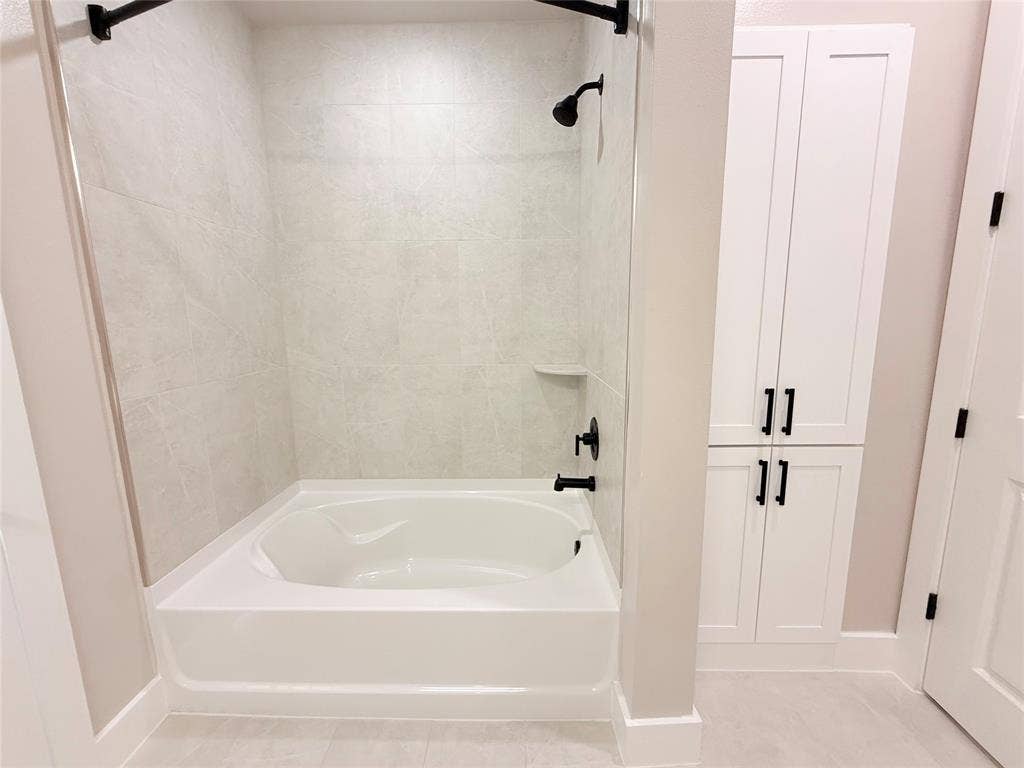 3255 Carlisle Street, #1207, Dallas, TX 75204 Bathroom featuring shower / bathtub combination and light tile patterned flooring