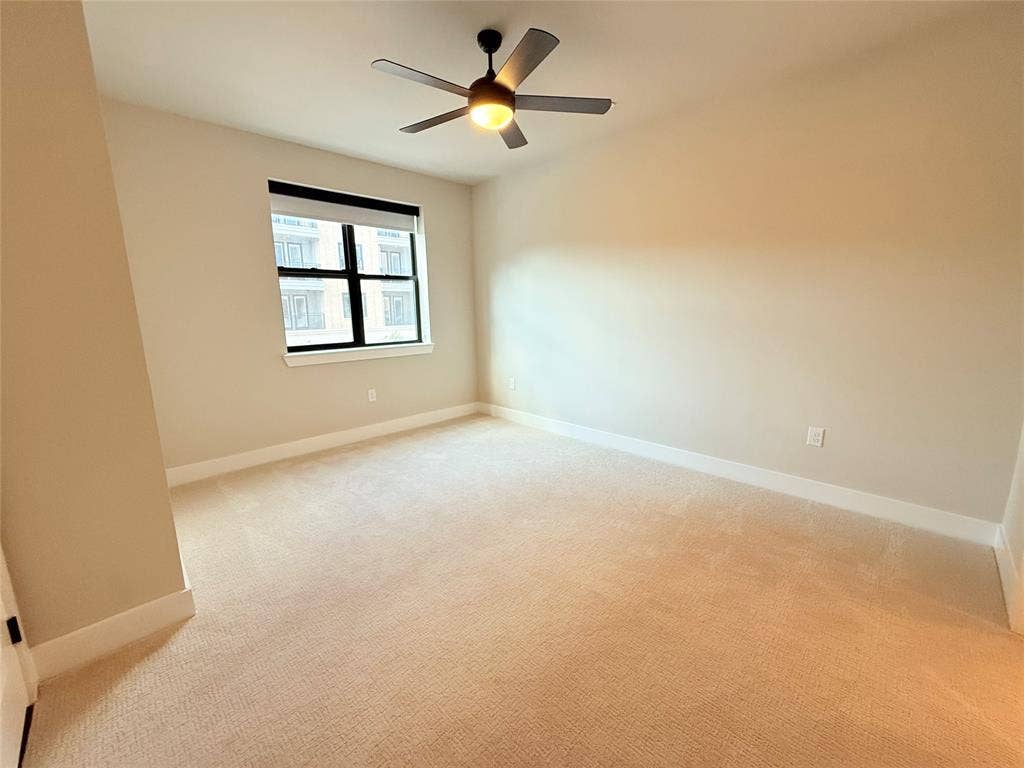 3255 Carlisle Street, #1207, Dallas, TX 75204 Unfurnished room with light colored carpet and a ceiling fan