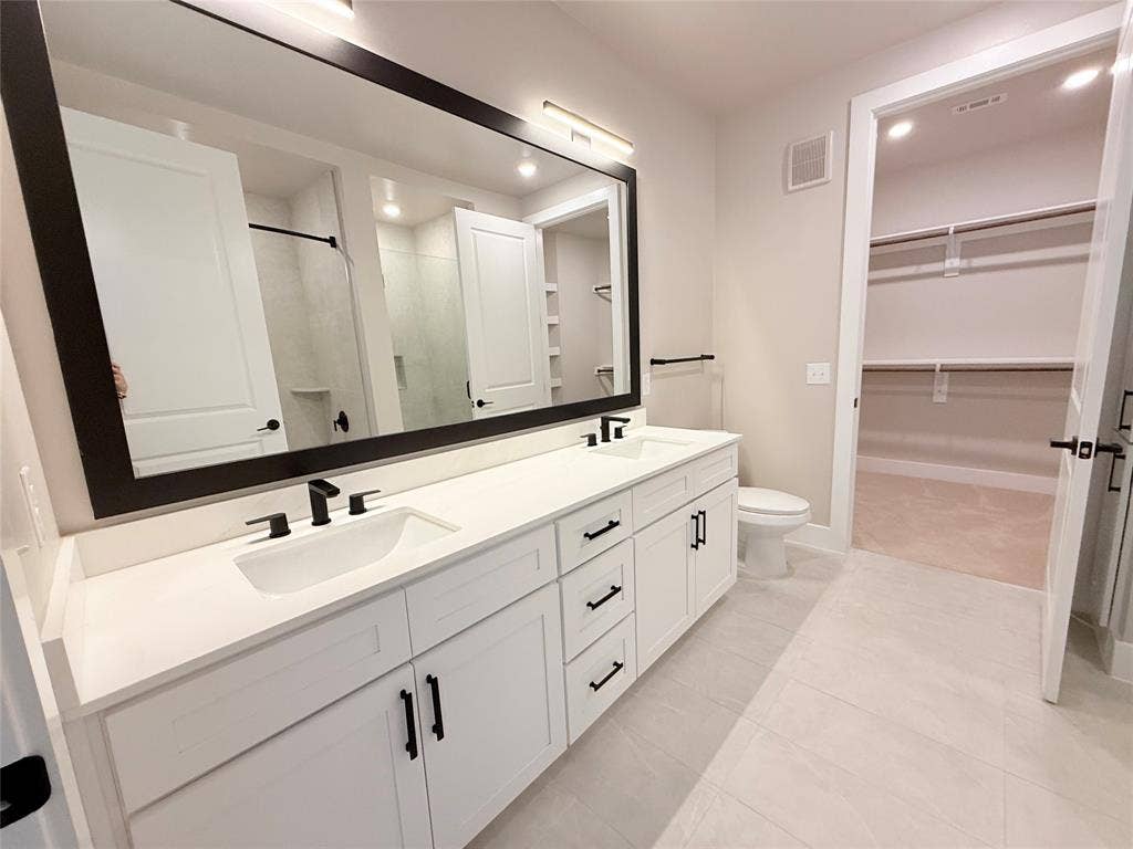 3255 Carlisle Street, #1207, Dallas, TX 75204 Full bath featuring a shower stall, double vanity, a walk in closet, recessed lighting, and light tile patterned flooring