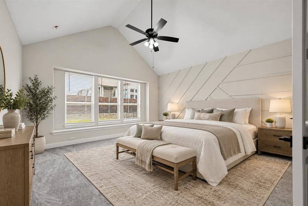 Vaulted ceiling with an integrated matte black ceiling fan, expansive triple-pane window arrangement, and custom geometric wall paneling