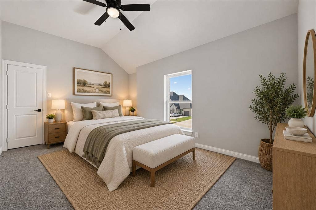 Vaulted ceiling with a matte black integrated ceiling fan, neutral wall tones, and crisp white paneled door