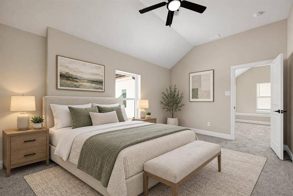 Vaulted ceiling, neutral wall tones, wall-to-wall carpeting, and a ceiling fan with integrated lighting
