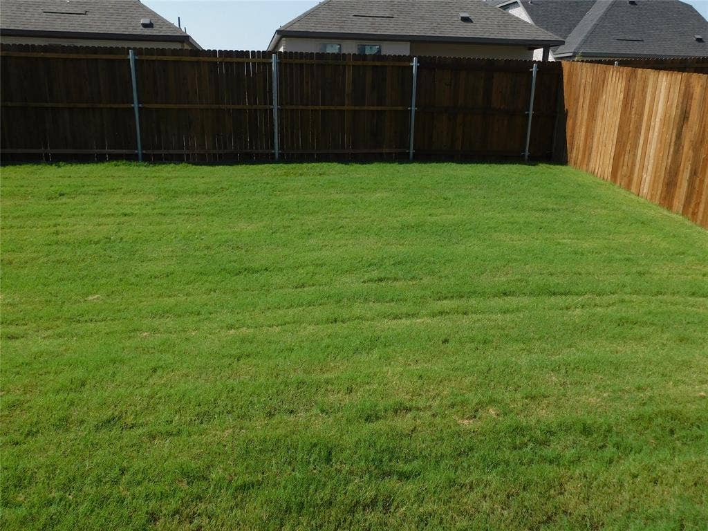 2702 Baynes Place, Princeton, TX 75407 Backyard featuring a grass lawn enclosed by wood privacy fencing