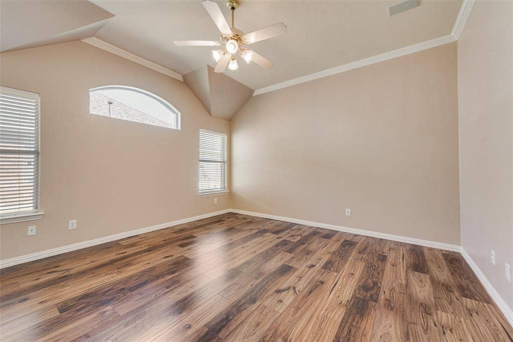 7900 Brookmount Street, Plano, TX 75024 Vaulted ceilings, wood-finish flooring, arched window, and overhead ceiling fan with multi-light fixture