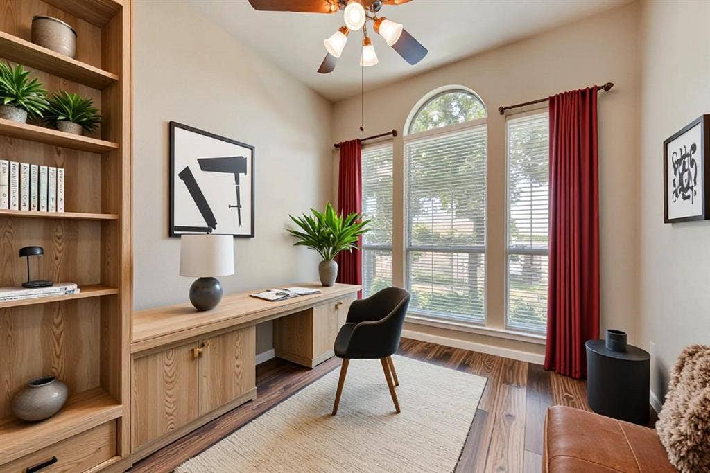 7900 Brookmount Street, Plano, TX 75024 Built-in wood cabinetry, expansive wood-finish flooring, ceiling fan, and large windows featuring an arched transom