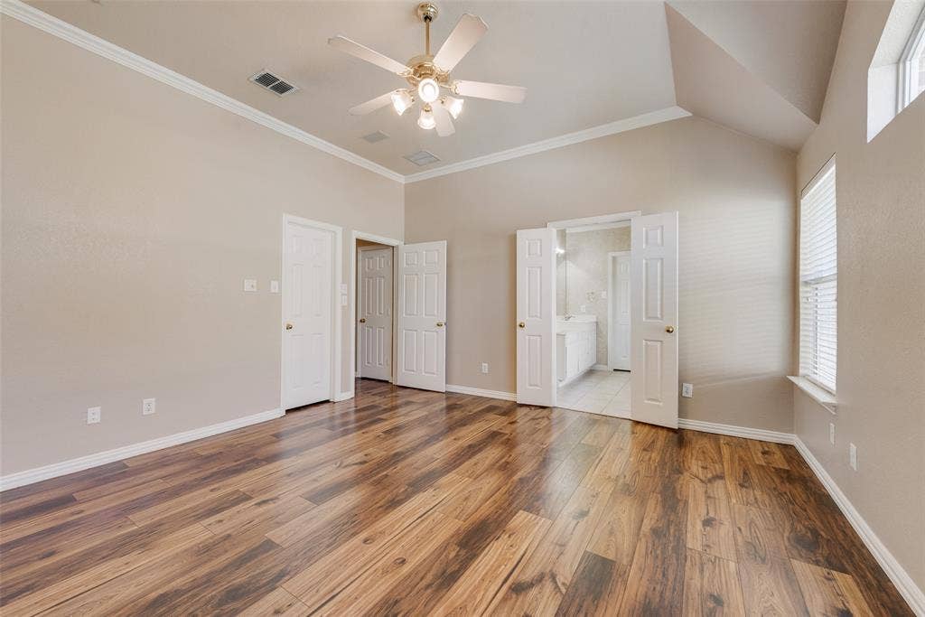 7900 Brookmount Street, Plano, TX 75024 Vaulted ceilings, wood-finish flooring, recessed lighting, and white six-panel interior doors