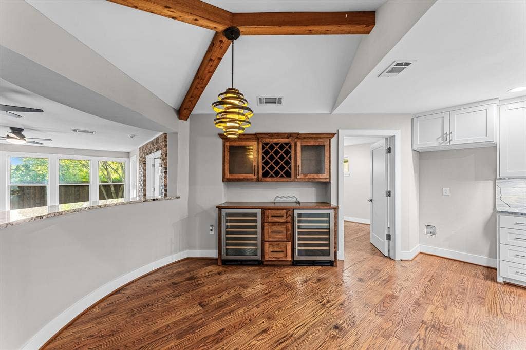 9656 Ravensway Drive, Dallas, TX 75238 The breakfast area features a bar and exposed wooden beams.