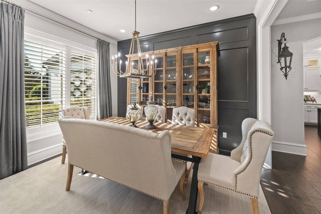 7609 Timber Trail, Tyler, TX 75703 Dining room featuring dark wood-finish flooring, custom-paneled accent wall, plantation shutters, recessed lighting, and a multi-tiered chandelier
