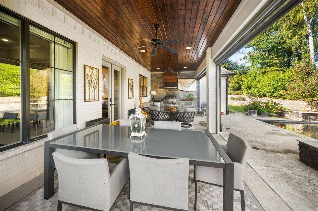 7609 Timber Trail, Tyler, TX 75703 Covered patio featuring a stained wood plank ceiling, recessed lighting, brick exterior walls, and an outdoor kitchen with stone masonry finishes