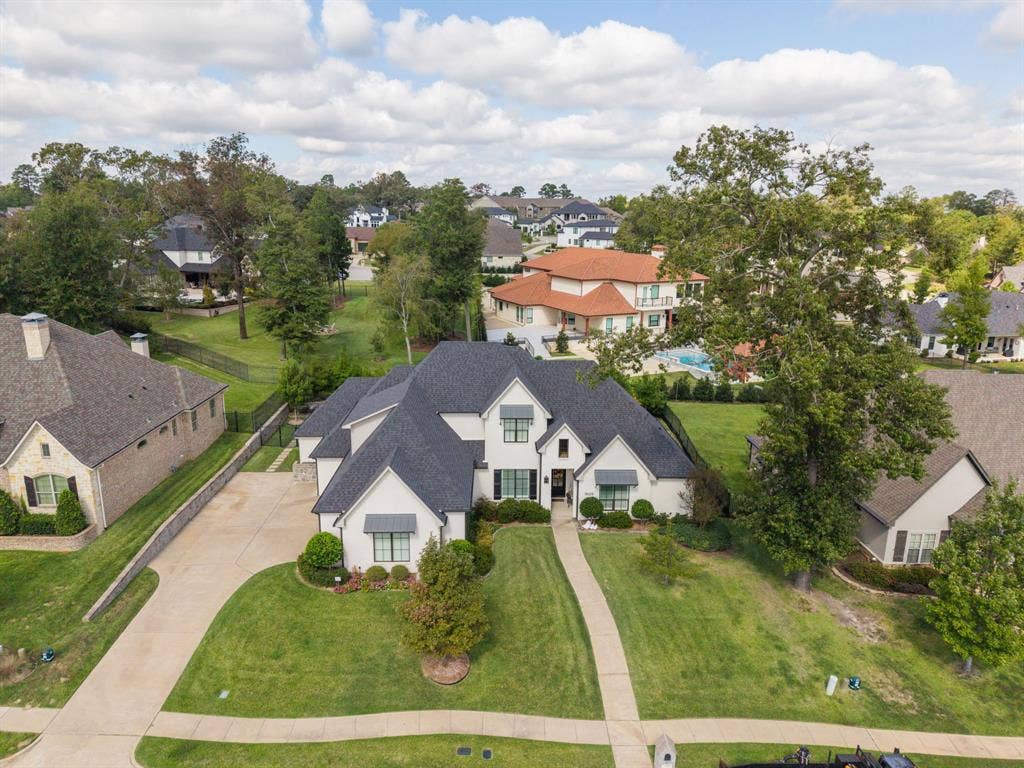 7609 Timber Trail, Tyler, TX 75703 Multi-gabled roofline with shingled exterior, light-toned masonry facade, decorative metal window awnings, and multi-car concrete driveway