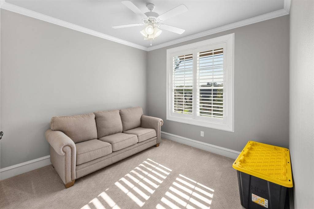 7609 Timber Trail, Tyler, TX 75703 Neutral-toned room featuring plush carpeting, a white ceiling fan with integrated lighting, and plantation-style window shutters