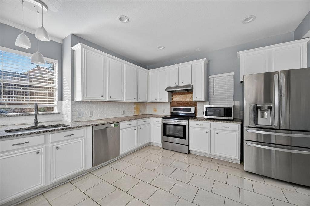 5726 Remington Drive, Garland, TX 75044 Kitchen featuring white shaker-style cabinetry, stone countertops, stainless steel appliances, tile flooring, and recessed lighting