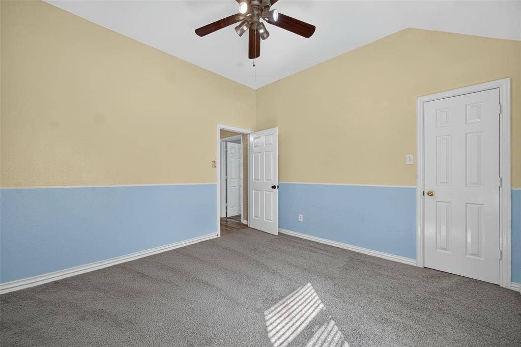 5726 Remington Drive, Garland, TX 75044 Vaulted ceilings featuring a multi-blade ceiling fan, neutral wall-to-wall carpeting, and six-panel interior doors