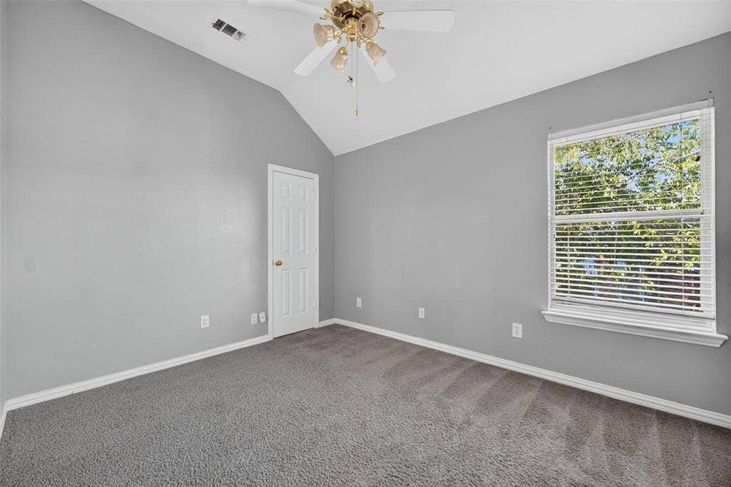 5726 Remington Drive, Garland, TX 75044 Vaulted ceilings, neutral wall tones, neutral carpeting, multi-pane window with blinds, and ceiling fan fixture