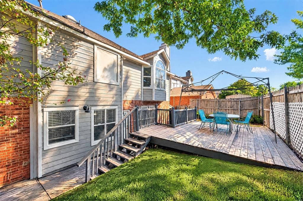 5726 Remington Drive, Garland, TX 75044 Exterior featuring a raised wood deck, metal-frame gazebo, brick and siding facade, and a fenced backyard