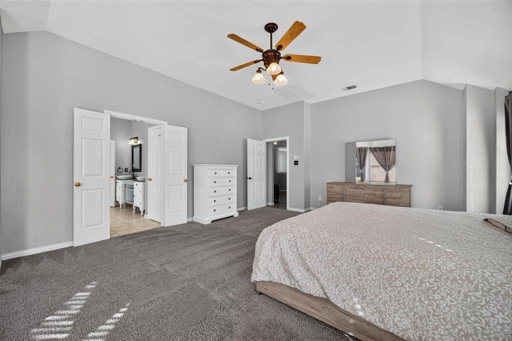 5726 Remington Drive, Garland, TX 75044 Vaulted ceilings, neutral wall tones, carpeted flooring, and a central ceiling fan with integrated lighting