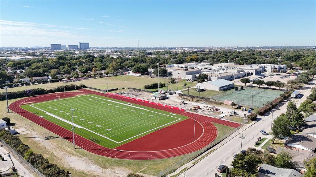1910 R Avenue, Plano, TX 75074 Aerial perspective featuring an artificial turf football field, multi-lane track, and paved tennis courts