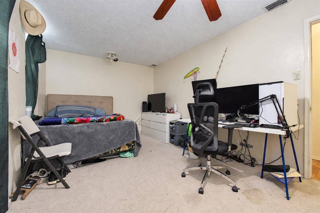 1910 R Avenue, Plano, TX 75074 Bedroom featuring neutral wall paint, carpeting, and a ceiling fan