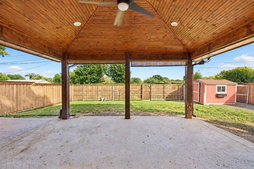 1910 R Avenue, Plano, TX 75074 Covered patio featuring a wood-planked vaulted ceiling, recessed lighting, ceiling fan, and concrete flooring, bounded by a wood privacy fence