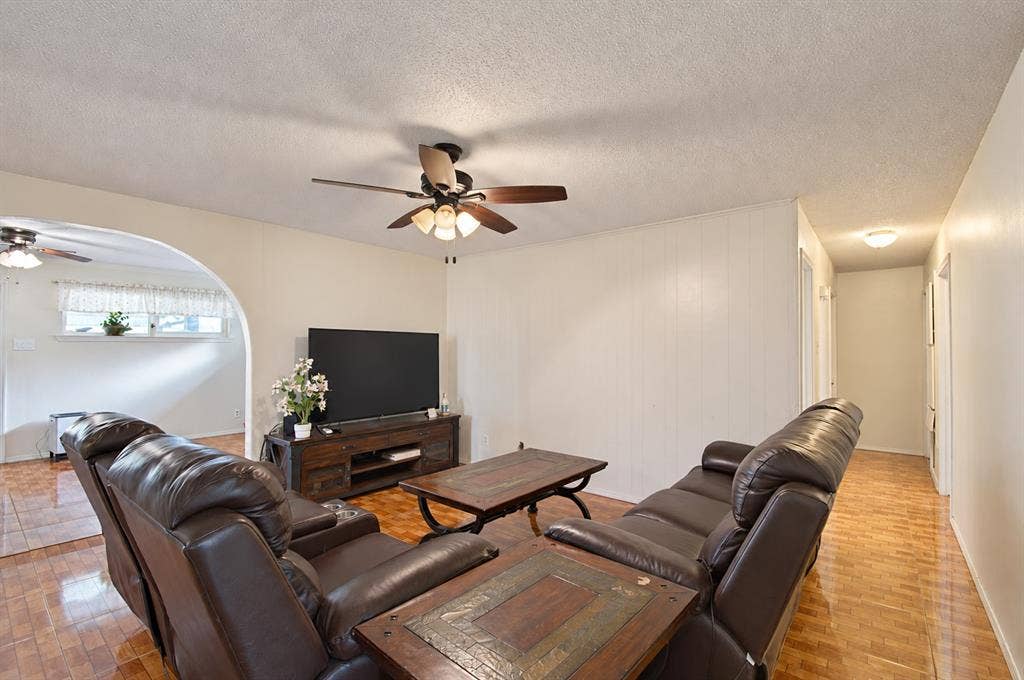 1910 R Avenue, Plano, TX 75074 Interior space featuring arched architectural detailing, tile flooring, and a ceiling-mounted fan with integrated light fixture