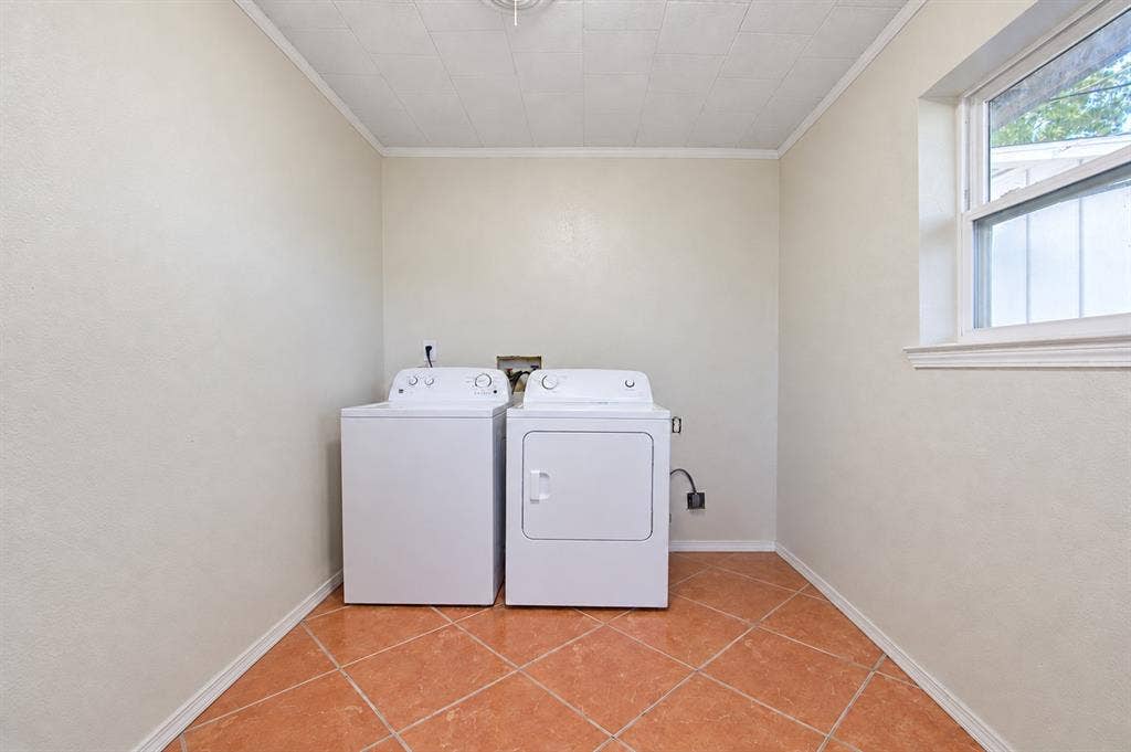 1910 R Avenue, Plano, TX 75074 Utility room featuring terracotta-style ceramic tile flooring, neutral wall finishes, and a single-pane window