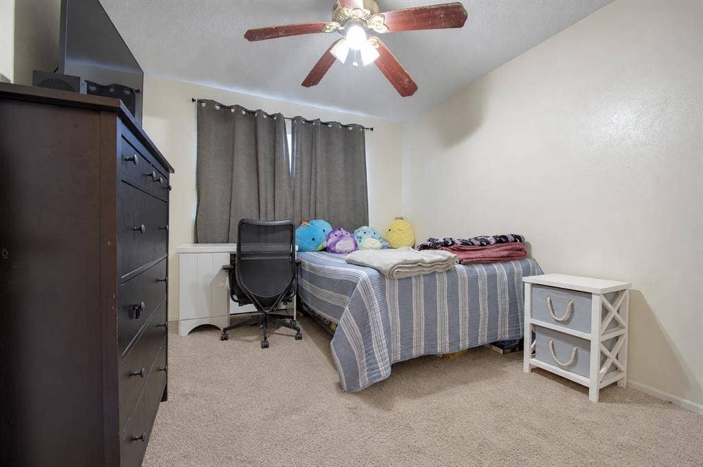 1910 R Avenue, Plano, TX 75074 Bedroom featuring carpeted flooring and a multi-blade ceiling fan with integrated lighting