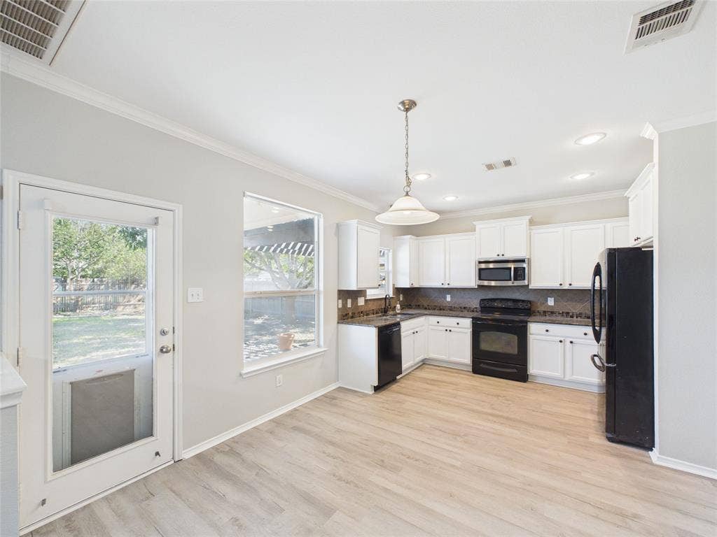 Kitchen featuring white cabinetry, wood-finish flooring, recessed lighting, a neutral-toned tile backsplash, and a pendant light fixture