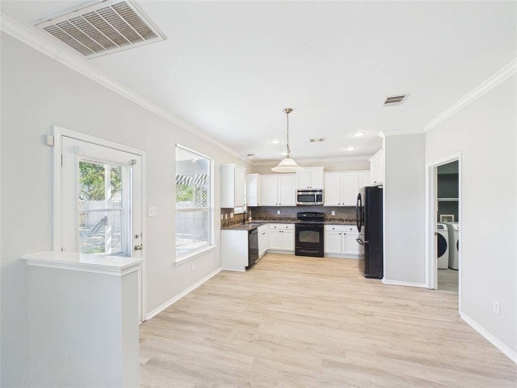 Kitchen featuring white cabinetry, wood-finish flooring, recessed lighting, and a pendant light fixture