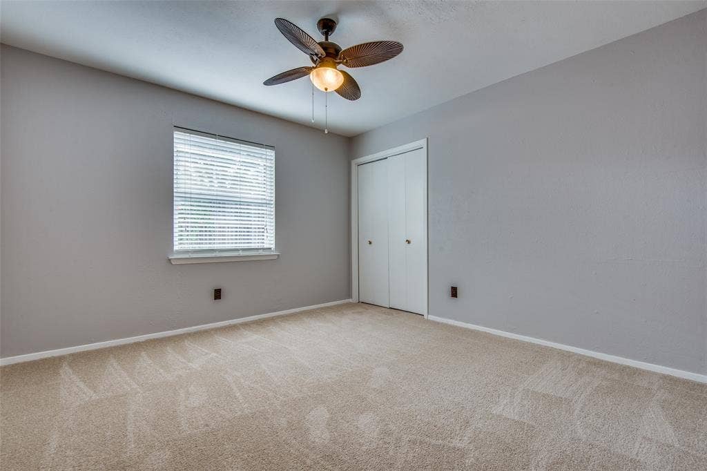 2131 Onetta Drive, Irving, TX 75061 Neutral interior featuring wall-to-wall carpeting, a multi-blade ceiling fan with integrated lighting, and a bi-fold closet