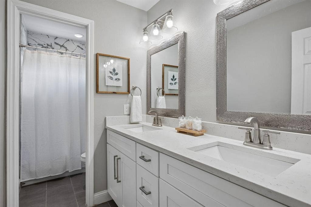 218 High Brook Drive, Richardson, TX 75080 The hall bath provides a clean and bright aesthetic with quartz counters.