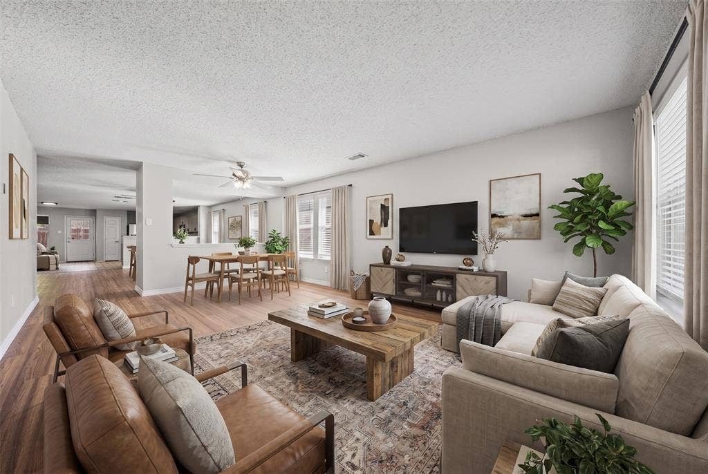 5428 Maverick Drive, Grand Prairie, TX 75052 Open-concept interior featuring wood-finish flooring, a neutral color palette, and a ceiling-mounted light fixture with integrated fan