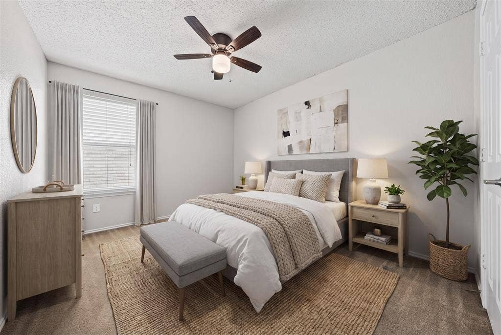 5428 Maverick Drive, Grand Prairie, TX 75052 Neutral-toned room featuring wall-to-wall carpeting, window with blinds, and a ceiling-mounted fan with light fixture