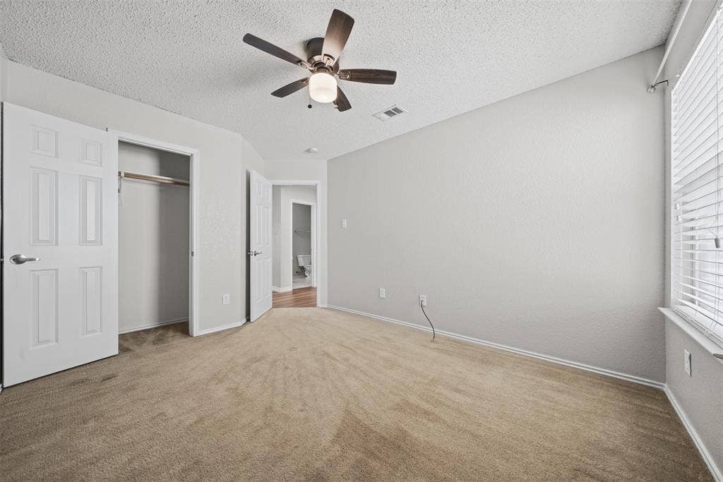 5428 Maverick Drive, Grand Prairie, TX 75052 Neutral-toned carpeting, ceiling fan with integrated lighting, and horizontal window blinds