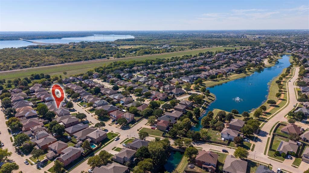 5428 Maverick Drive, Grand Prairie, TX 75052 Aerial perspective showcasing a residential property with proximity to a community lake and established neighborhood landscaping