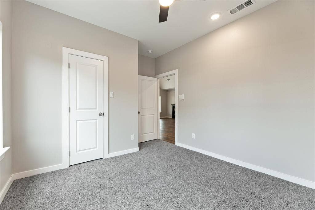 1242 Seminole Drive, Dallas, TX 75217 Neutral-toned interior space featuring wall-to-wall carpeting, two-panel interior doors, recessed lighting, and a ceiling fan