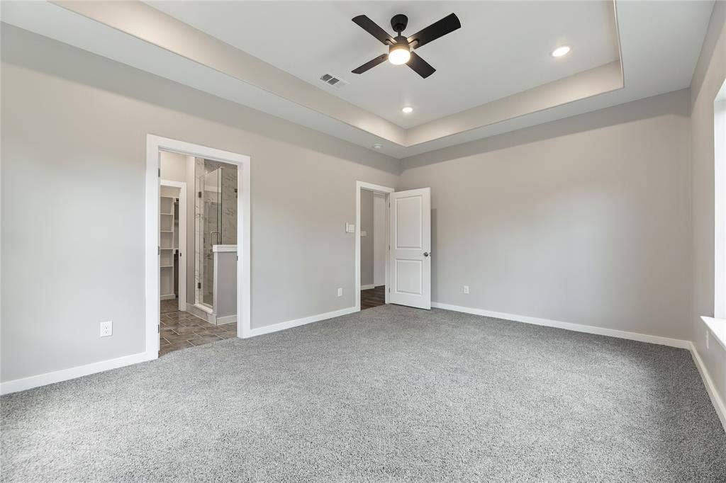 1242 Seminole Drive, Dallas, TX 75217 Tray ceiling featuring a central matte black ceiling fan, recessed lighting, and wall-to-wall carpeting