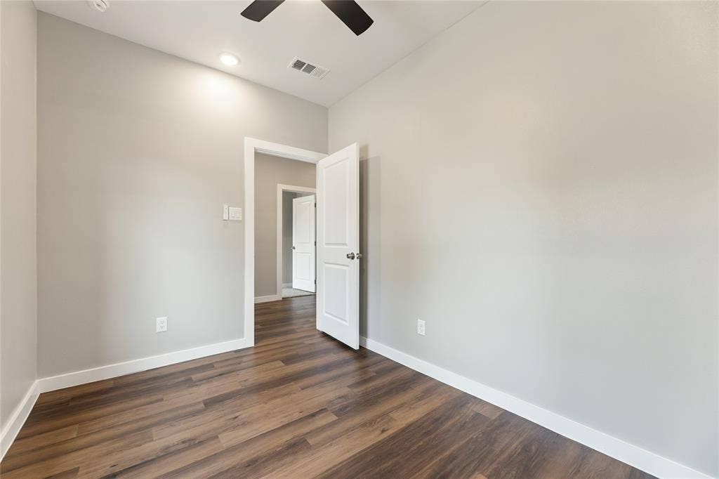 1242 Seminole Drive, Dallas, TX 75217 Neutral-toned walls, wood-finish flooring, recessed lighting, ceiling fan, and multi-panel interior doors