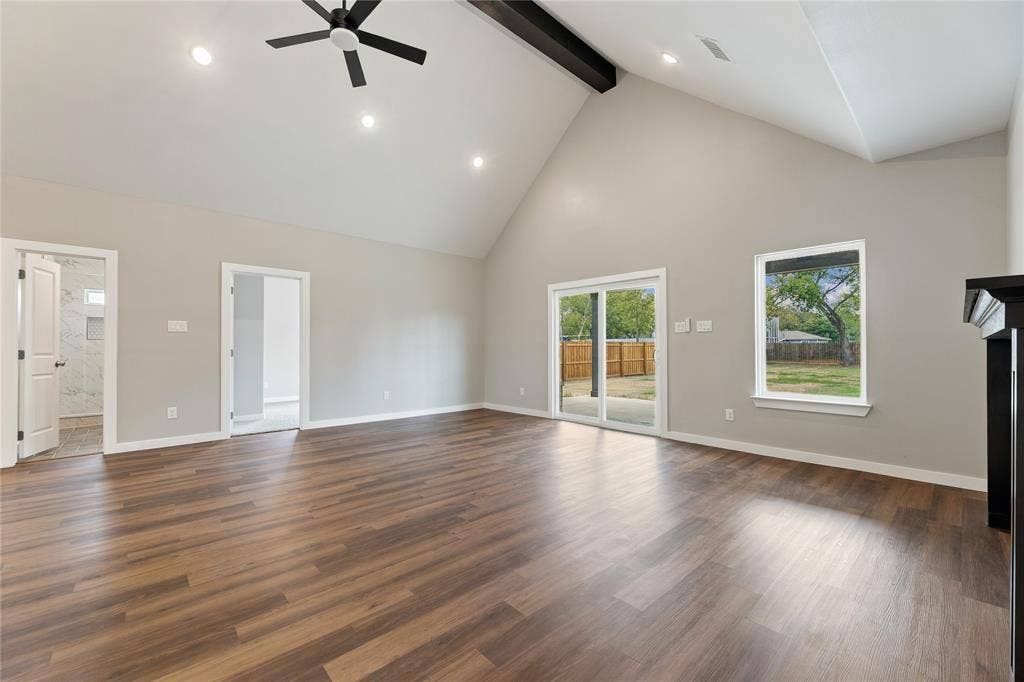 1242 Seminole Drive, Dallas, TX 75217 Vaulted ceilings featuring a dark wood-finish structural beam, wood-finish flooring, sliding glass door, and recessed lighting