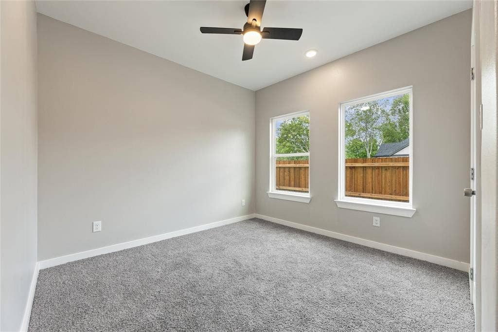 1242 Seminole Drive, Dallas, TX 75217 Room featuring neutral wall paint, plush carpeting, a modern ceiling fan with integrated lighting, and dual windows