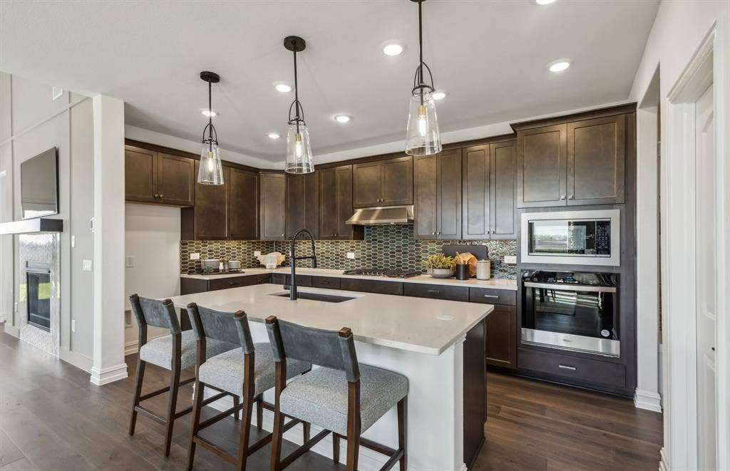 4149 Gonzales Drive, McKinney, TX 75071 *Model Representation - Spacious kitchen with eat-in bartop island