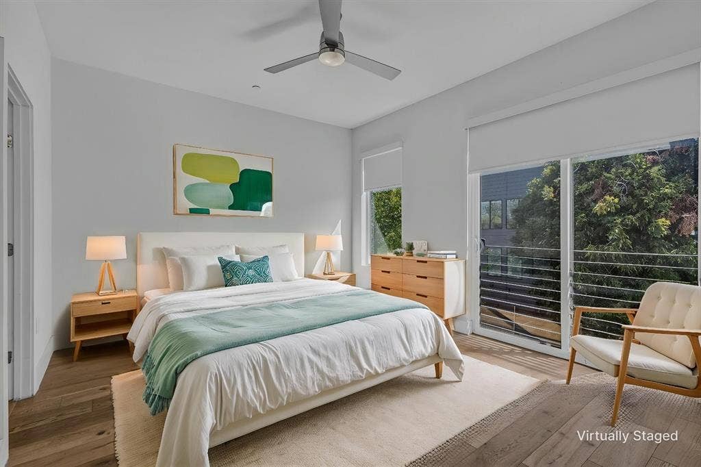 2222 Moser Avenue, #105, Dallas, TX 75206 Wood-finish flooring, ceiling fan with integrated lighting, sliding glass door, and metal balcony railing