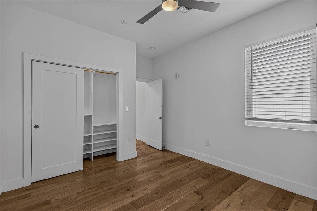 2222 Moser Avenue, #105, Dallas, TX 75206 Wood-finish flooring, recessed lighting, ceiling fan with integrated light, sliding closet door with built-in shelving, and window with horizontal blinds