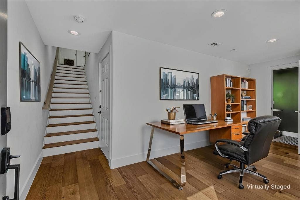 2222 Moser Avenue, #105, Dallas, TX 75206 Wood-finish flooring, staircase with a wood-finished handrail, recessed lighting, and built-in shelving