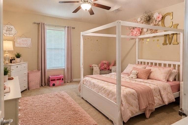 Bedroom featuring carpeted flooring, neutral wall paint, and a ceiling-mounted light fixture with integrated fan