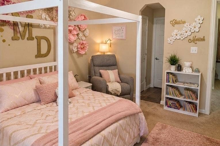 Neutral wall tones, carpeted flooring, and a multi-panel door leading to a separate room area