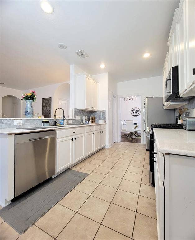 4308 Lee Hutson Drive, Sachse, TX 75048 Kitchen featuring white shaker-style cabinetry, solid-surface countertops, stone-tile backsplash, stainless steel dishwasher, and recessed lighting