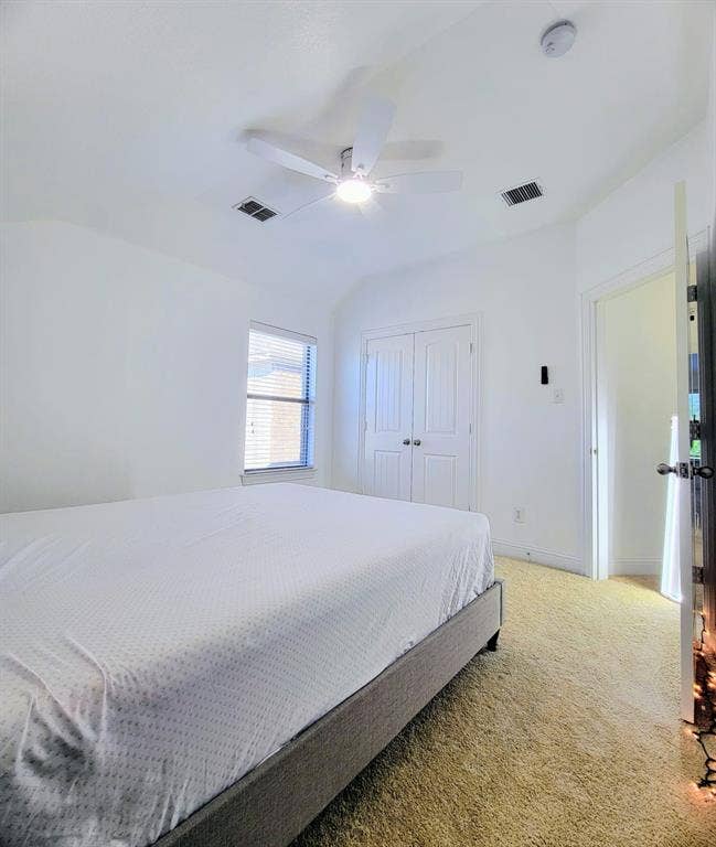 4308 Lee Hutson Drive, Sachse, TX 75048 Room featuring vaulted ceilings, a central ceiling fan with integrated lighting, carpeted flooring, and a closet with double doors