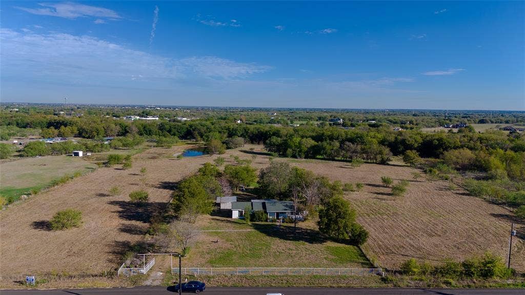 212 Old Wagon Road, Royse City, TX 75189 Expansive acreage featuring a single-story residence, mature tree clusters, and a private pond