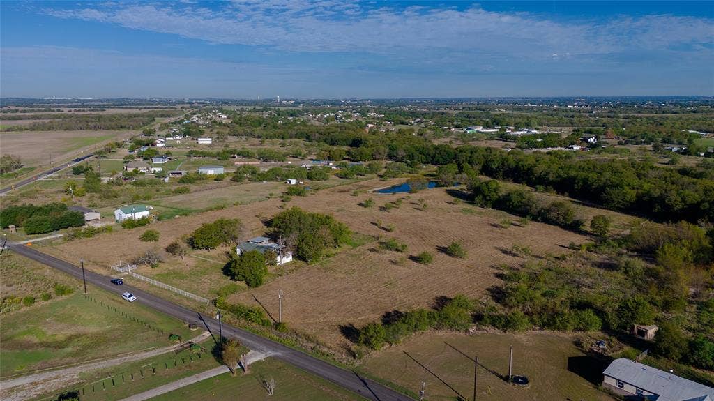 212 Old Wagon Road, Royse City, TX 75189 Expansive acreage featuring mature trees, a private pond, and frontage along a paved road
